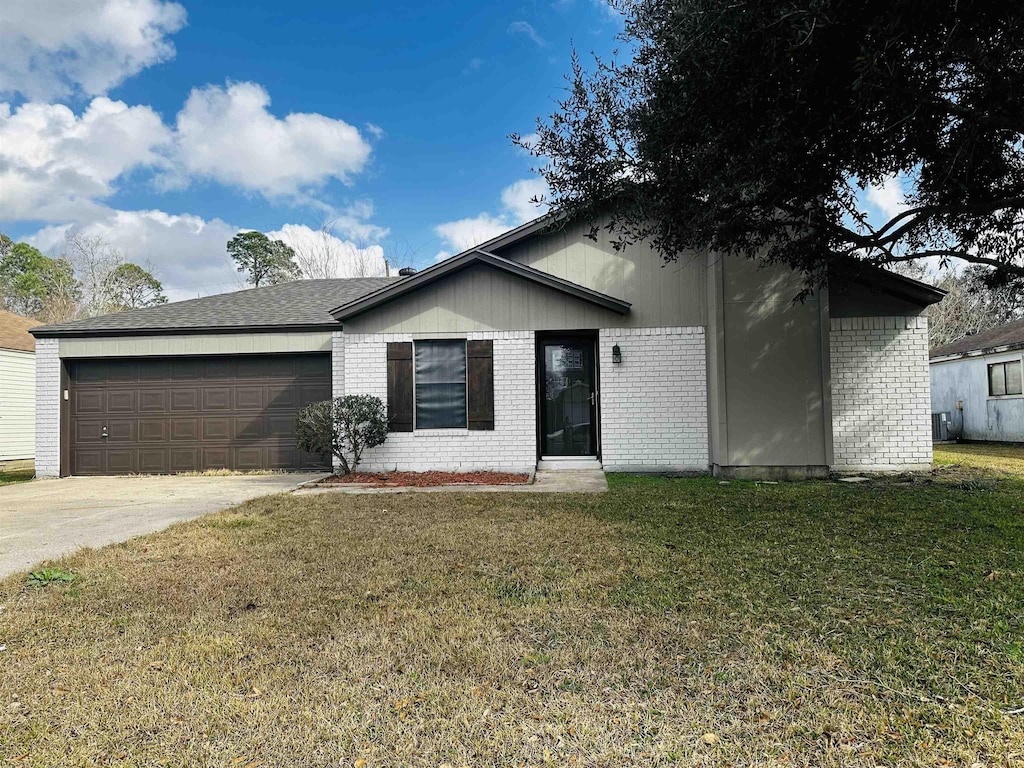 ranch-style home with a garage and a front yard