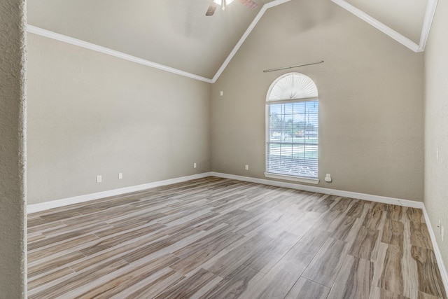 unfurnished room featuring ceiling fan, light hardwood / wood-style floors, crown molding, and high vaulted ceiling