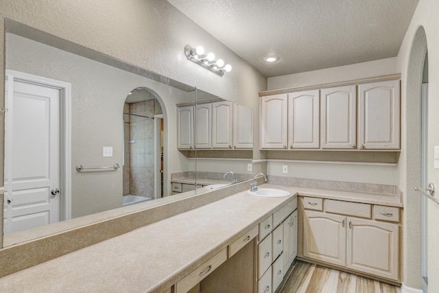 bathroom with vanity, a textured ceiling, and hardwood / wood-style flooring