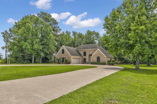 view of front of property featuring a garage and a front lawn