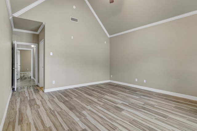 spare room with ceiling fan, high vaulted ceiling, light hardwood / wood-style floors, and ornamental molding