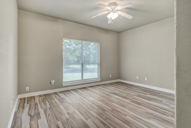 unfurnished room with ceiling fan and light hardwood / wood-style flooring