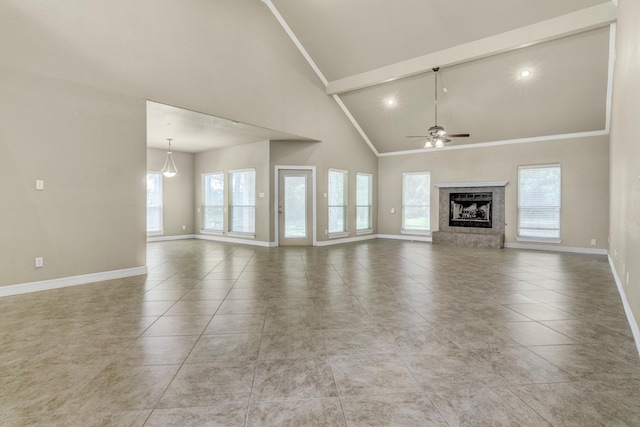 unfurnished living room featuring light tile patterned flooring, ceiling fan, high vaulted ceiling, and a healthy amount of sunlight