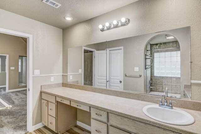 bathroom featuring vanity, a textured ceiling, and independent shower and bath