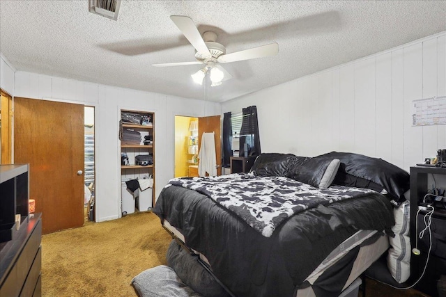 bedroom with visible vents, carpet floors, a textured ceiling, and ceiling fan