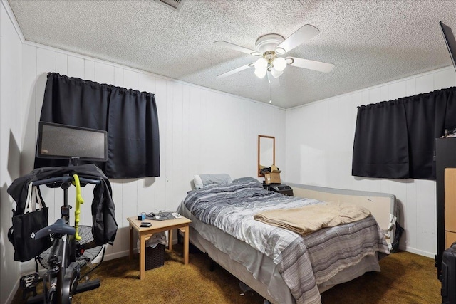 carpeted bedroom featuring a textured ceiling and ceiling fan