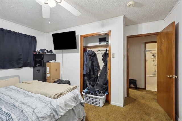 carpeted bedroom with a ceiling fan, a closet, and a textured ceiling