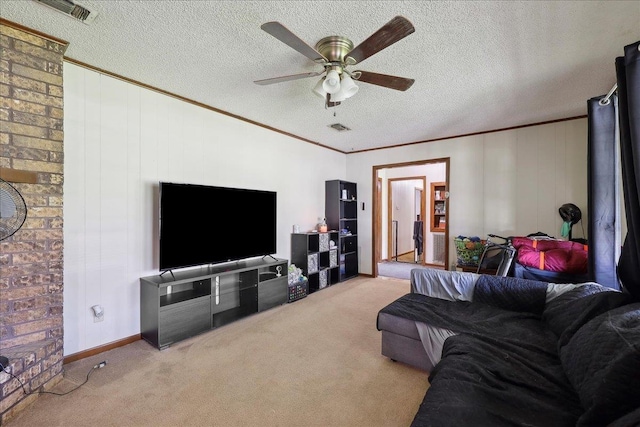 carpeted living room featuring ceiling fan, visible vents, a textured ceiling, and ornamental molding