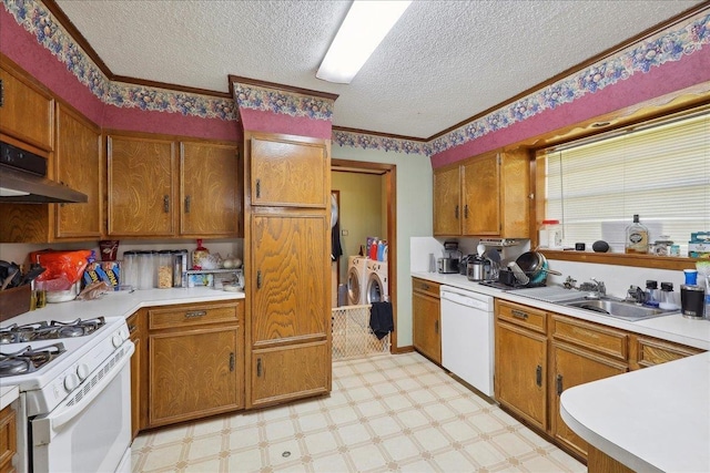 kitchen with under cabinet range hood, washing machine and dryer, white appliances, light countertops, and light floors