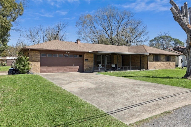 single story home with a front yard, an attached garage, brick siding, and driveway