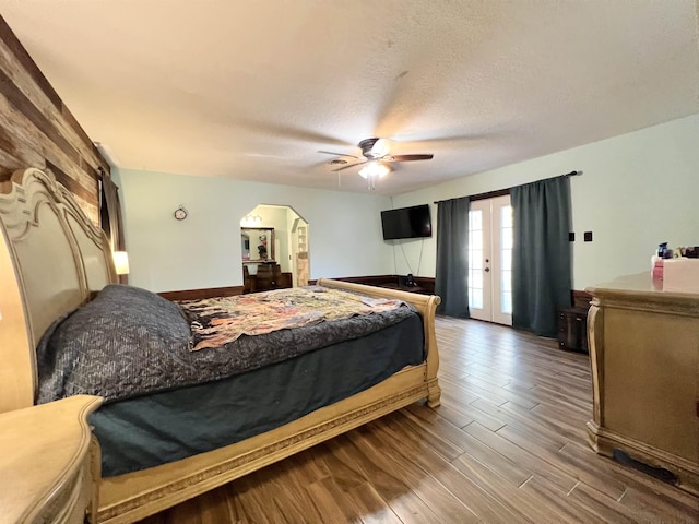 bedroom featuring ceiling fan, french doors, and a textured ceiling