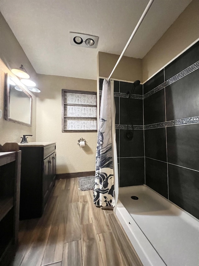 bathroom with a shower with curtain, vanity, and hardwood / wood-style flooring