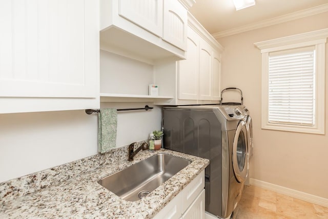 washroom featuring washer and clothes dryer, sink, ornamental molding, and cabinets