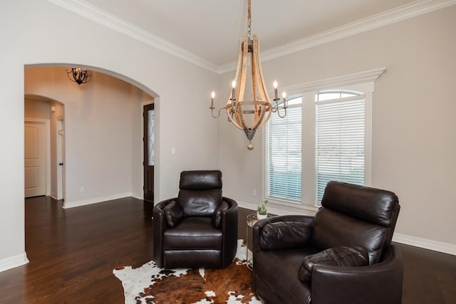 living area featuring dark hardwood / wood-style floors, crown molding, and a notable chandelier