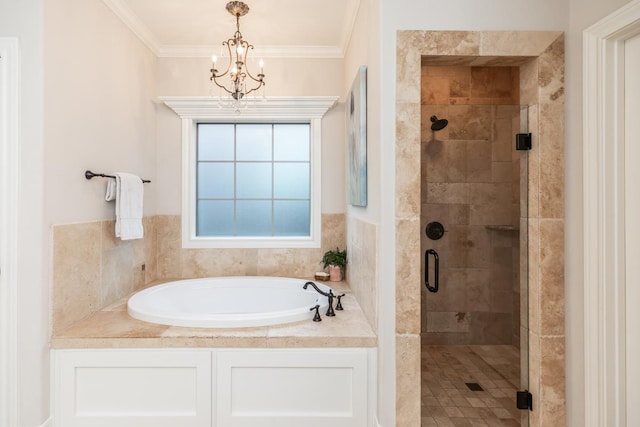 bathroom with an inviting chandelier, crown molding, and separate shower and tub