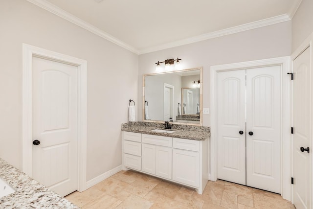 bathroom with ornamental molding and vanity