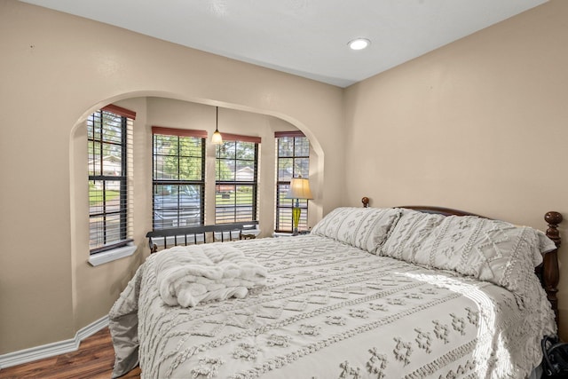 103 Read St, Silsbee, TX 77656 - bedroom with arched walkways, wood finished floors, multiple windows, and recessed lighting