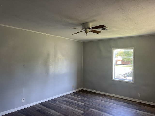 empty room featuring dark hardwood / wood-style floors, ceiling fan, and a textured ceiling