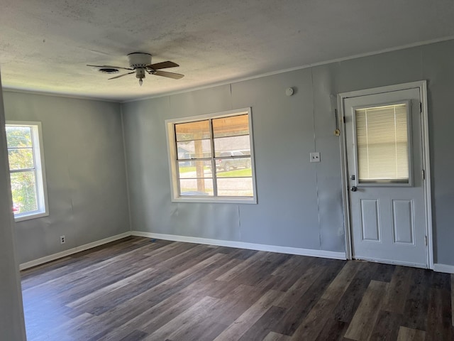 foyer with ceiling fan, dark hardwood / wood-style flooring, and a textured ceiling