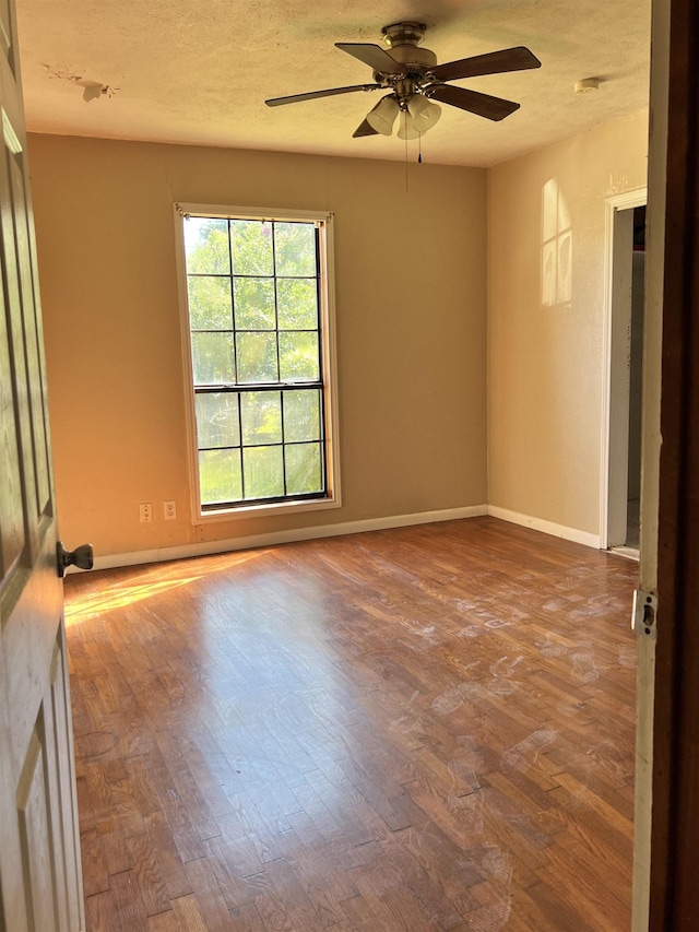 spare room featuring hardwood / wood-style floors and ceiling fan