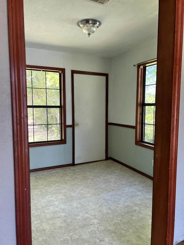 spare room featuring a healthy amount of sunlight