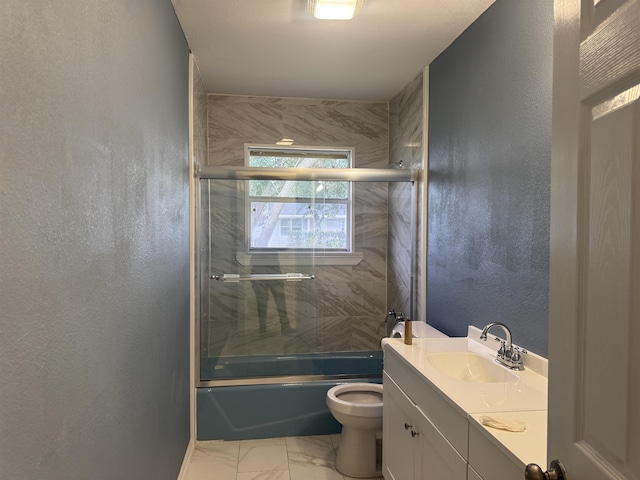 full bathroom featuring vanity, toilet, and bath / shower combo with glass door