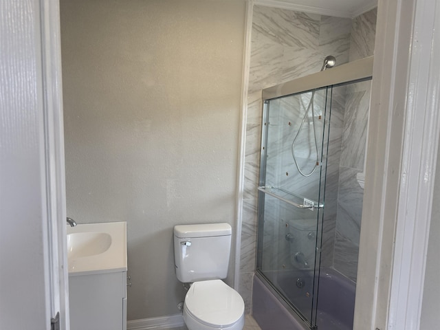 full bathroom with vanity, bath / shower combo with glass door, and toilet