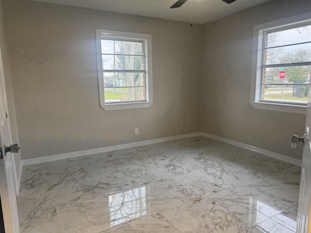 unfurnished room featuring a wealth of natural light and ceiling fan