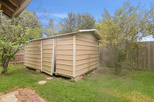 view of outbuilding with a lawn