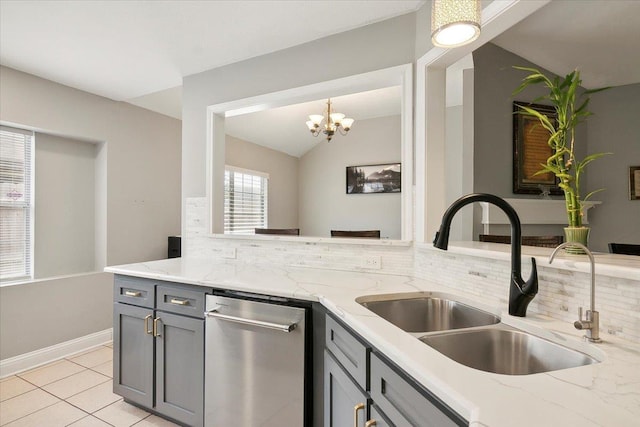 kitchen featuring gray cabinetry, light stone counters, and sink