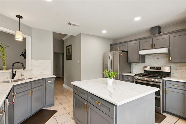 kitchen featuring stainless steel appliances, gray cabinets, and sink