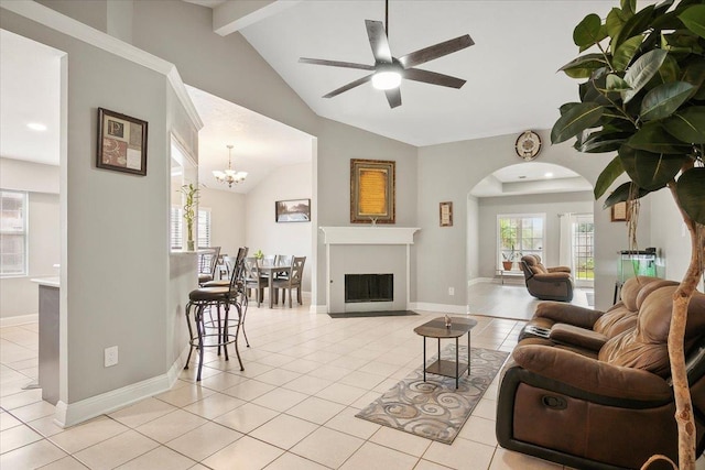 tiled living room featuring vaulted ceiling with beams and ceiling fan with notable chandelier