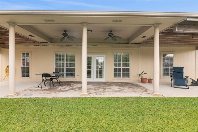 rear view of property featuring ceiling fan, a patio area, a yard, and french doors