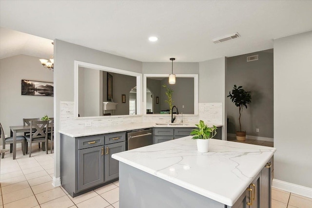 kitchen featuring gray cabinetry, dishwasher, sink, backsplash, and pendant lighting