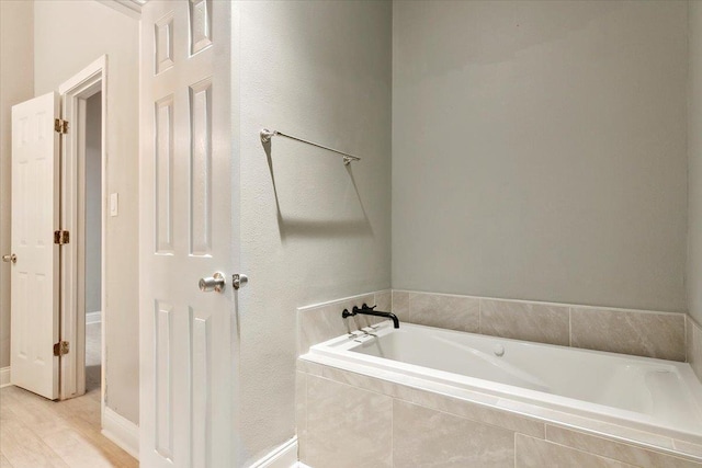 bathroom featuring a relaxing tiled tub