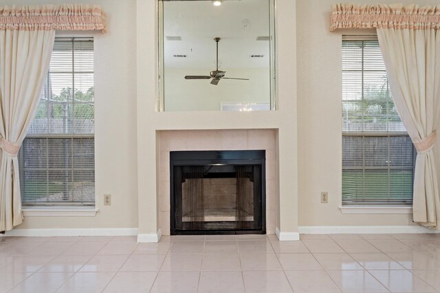 961 Green Mdw, Beaumont, TX 77706 - interior details with a tile fireplace, baseboards, and ceiling fan