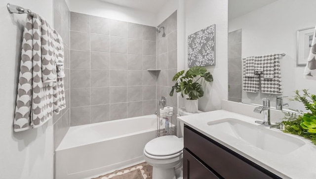 bathroom featuring vanity, shower / tub combination, and toilet