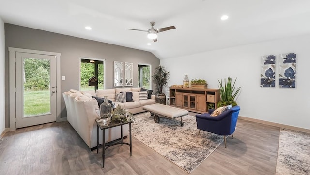 living room with recessed lighting, baseboards, wood finished floors, and vaulted ceiling