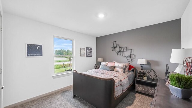 bedroom featuring baseboards and dark colored carpet