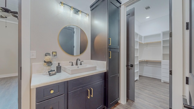 bathroom with vanity, hardwood / wood-style floors, and ceiling fan