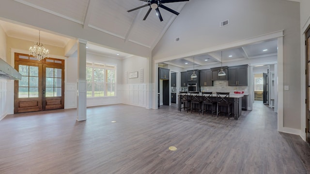 dining area featuring ornamental molding, high vaulted ceiling, dark hardwood / wood-style floors, and french doors