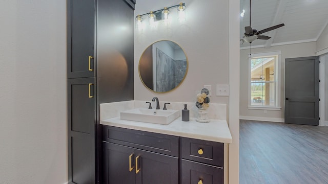 bathroom with vanity, vaulted ceiling with beams, hardwood / wood-style flooring, and ceiling fan