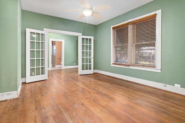 unfurnished room with hardwood / wood-style floors, french doors, and ceiling fan