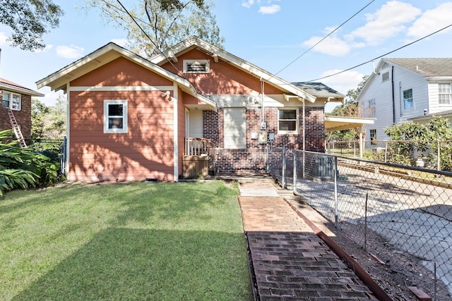 bungalow-style home with a front yard