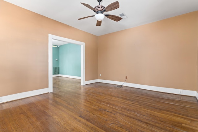 unfurnished room with ceiling fan and dark hardwood / wood-style flooring