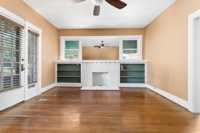 unfurnished living room featuring hardwood / wood-style flooring, a fireplace, and ceiling fan