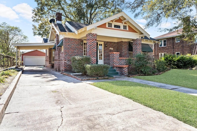 view of front of property with an outbuilding, a garage, and a front yard