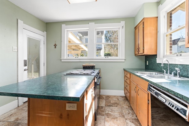 kitchen featuring dishwasher, sink, decorative backsplash, and stainless steel gas stove