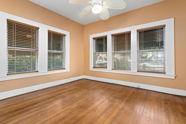 spare room featuring hardwood / wood-style floors and ceiling fan