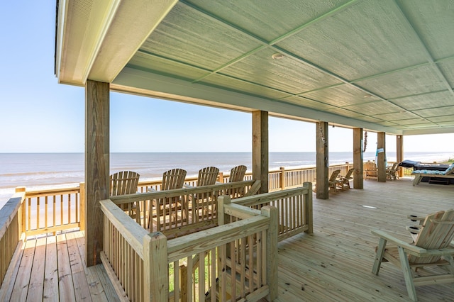 deck featuring a water view and a view of the beach